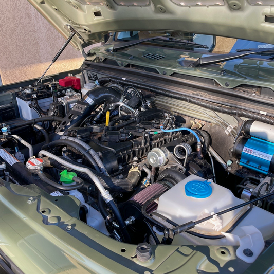 Jungle Green Suzuki Jimny JB74 engine bay with an AMV Garret Motion Turbo kit fitted