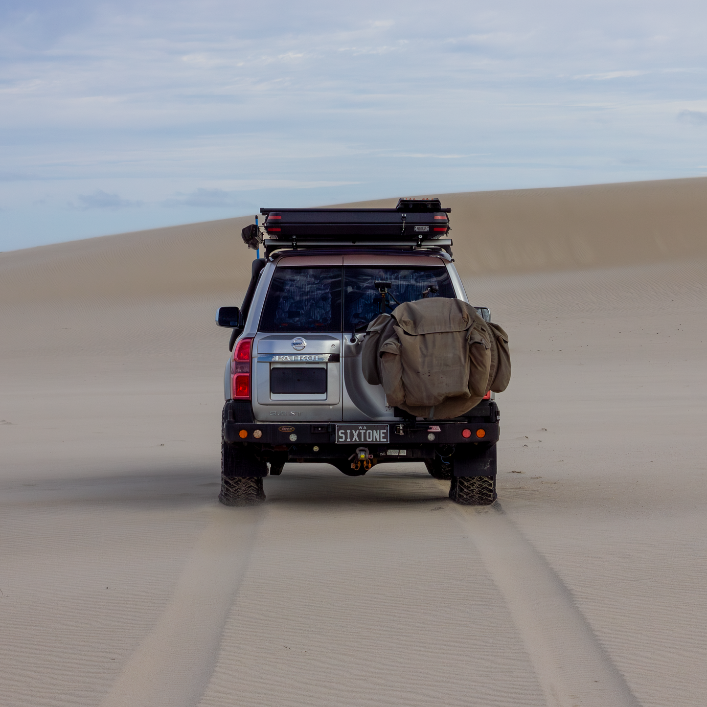 Silver ZD30 Nissan Patrol in beach landscape