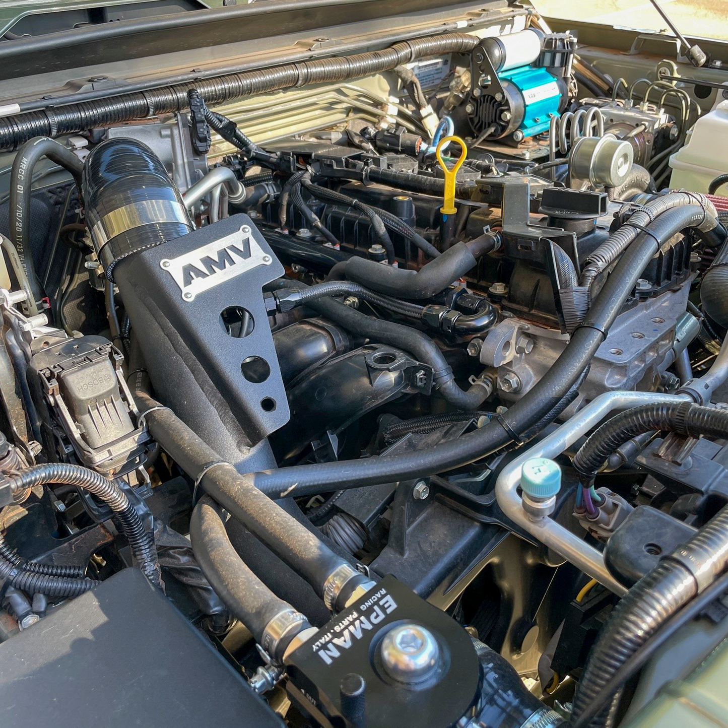 Kinetic Yellow Suzuki Jimny JB74 engine bay with an AMV Garret Motion Turbo kit fitted