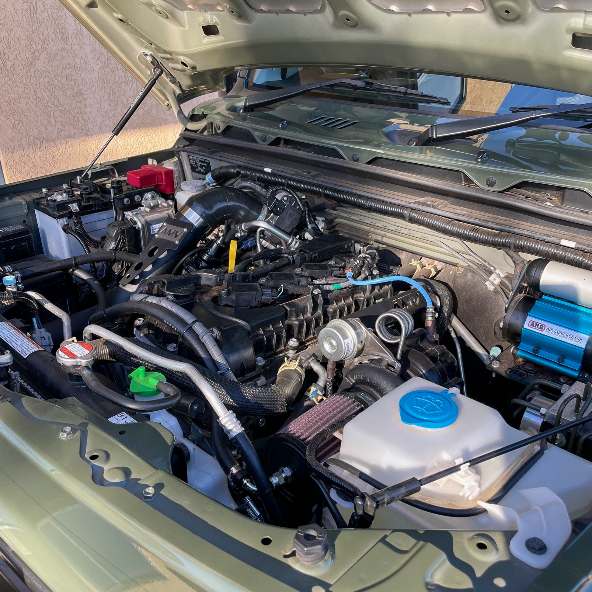 Jungle Green Suzuki Jimny JB74 engine bay with an AMV Garret Motion Turbo kit fitted