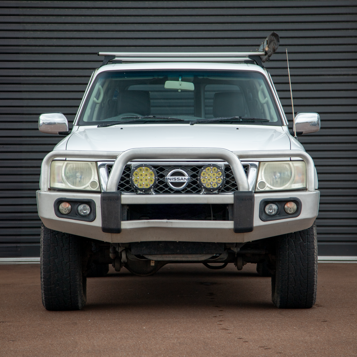 White TB48 Nissan Patrol in front of black roller door. 