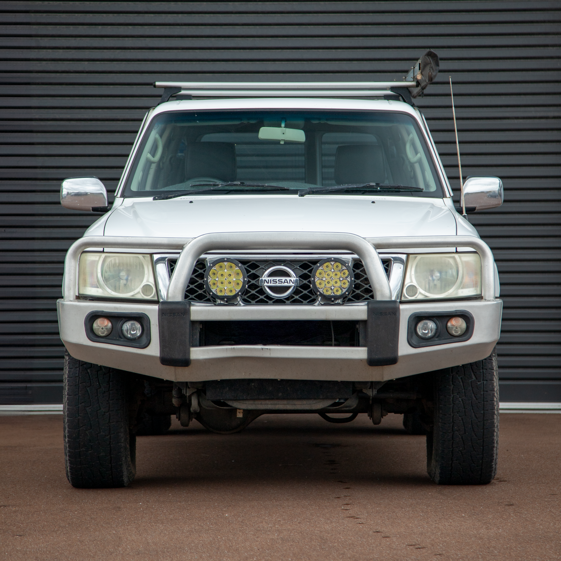 White TB48 Nissan Patrol in front of black roller door. 