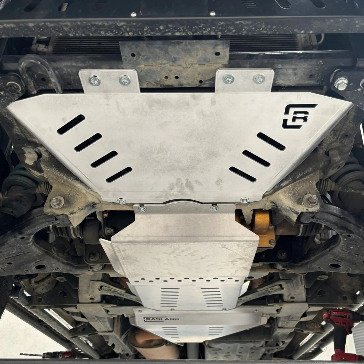 Undercarriage of a Nissan Y62 Patrol with a Raslarr bash plate.
