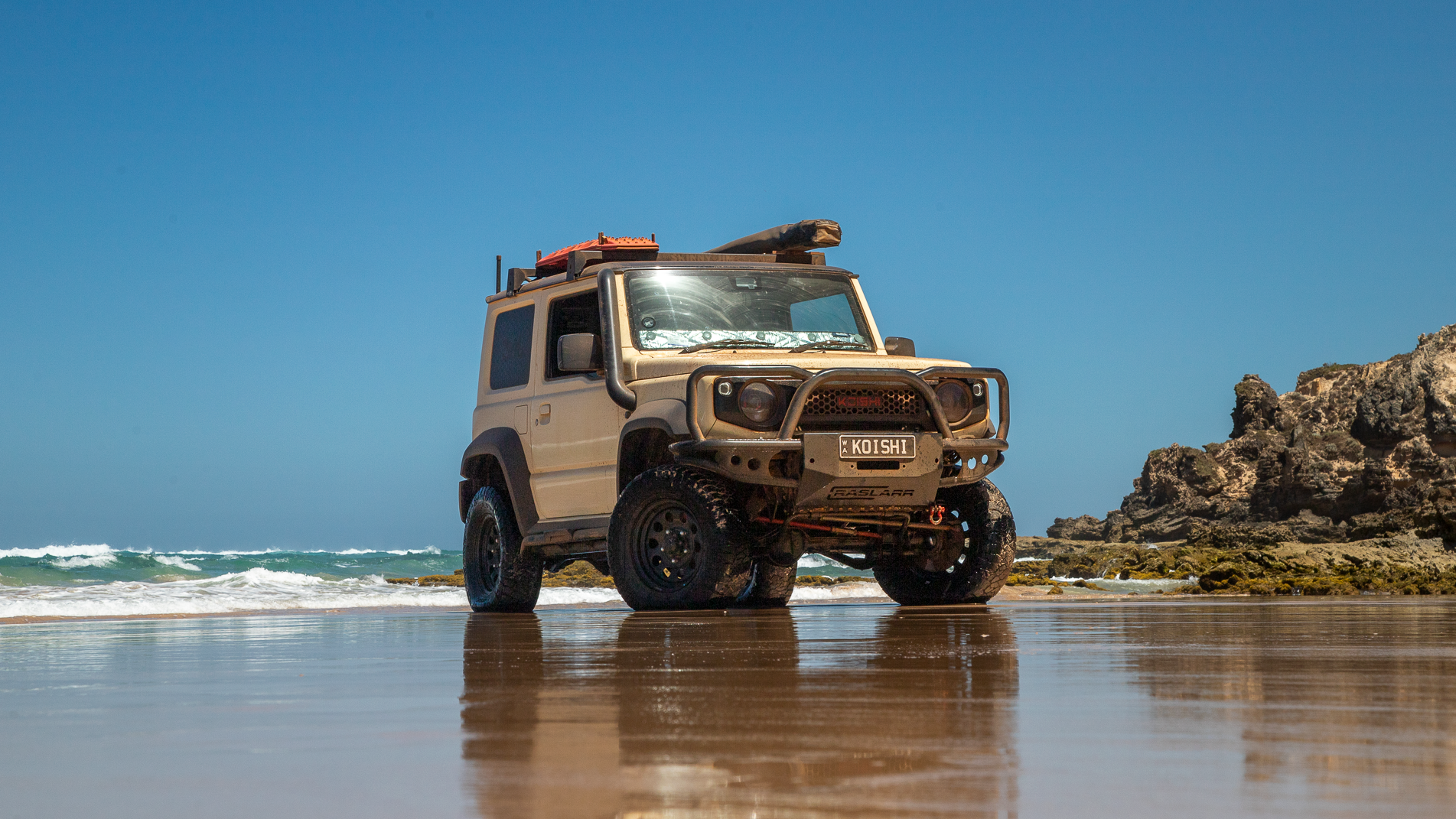 Koishi_The_Jimny JB74 Suzuki Jimny parked in the shallows on beach