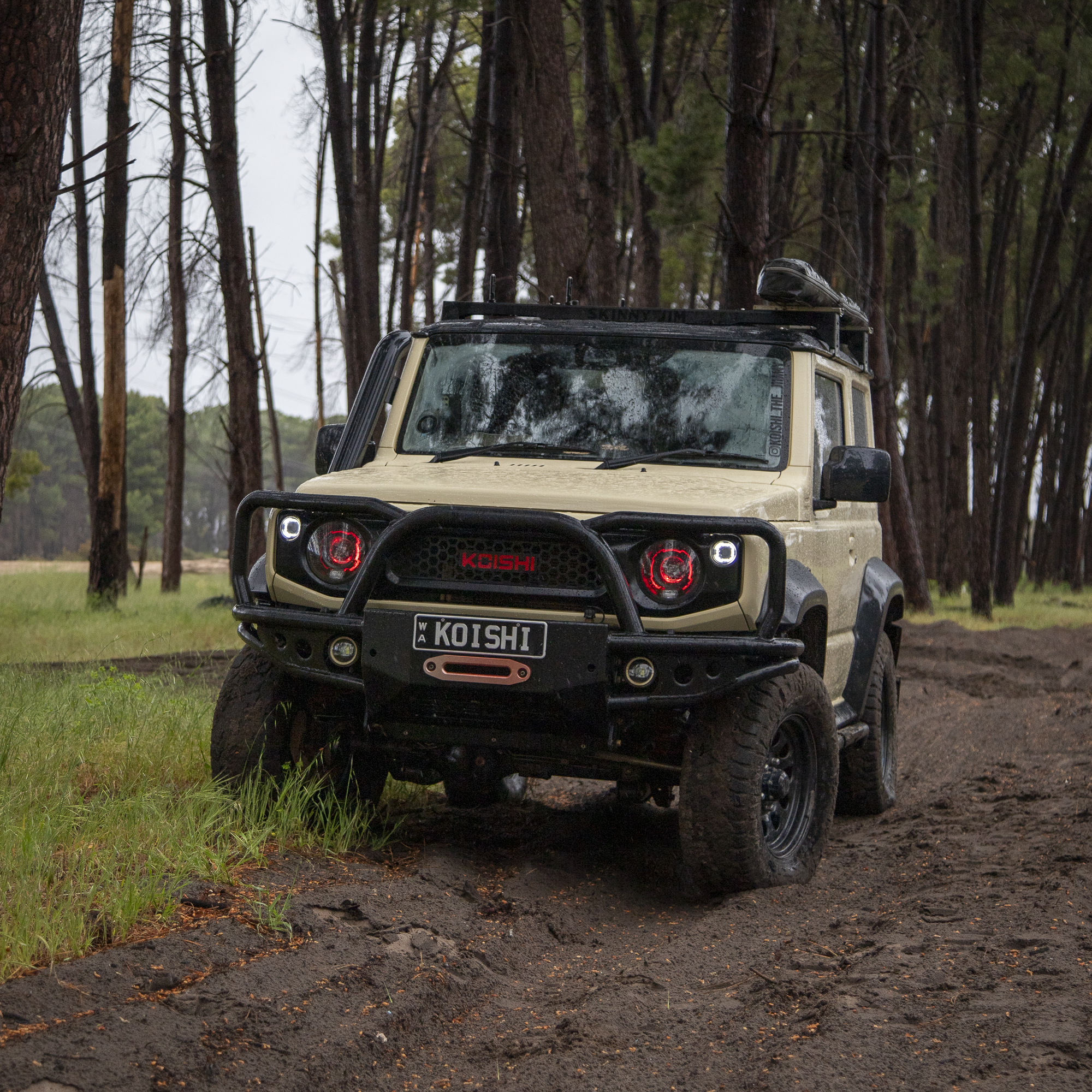 Koishi_The_Jimny JB74 Suzuki Jimny parked in moody forrest with red halo headlights